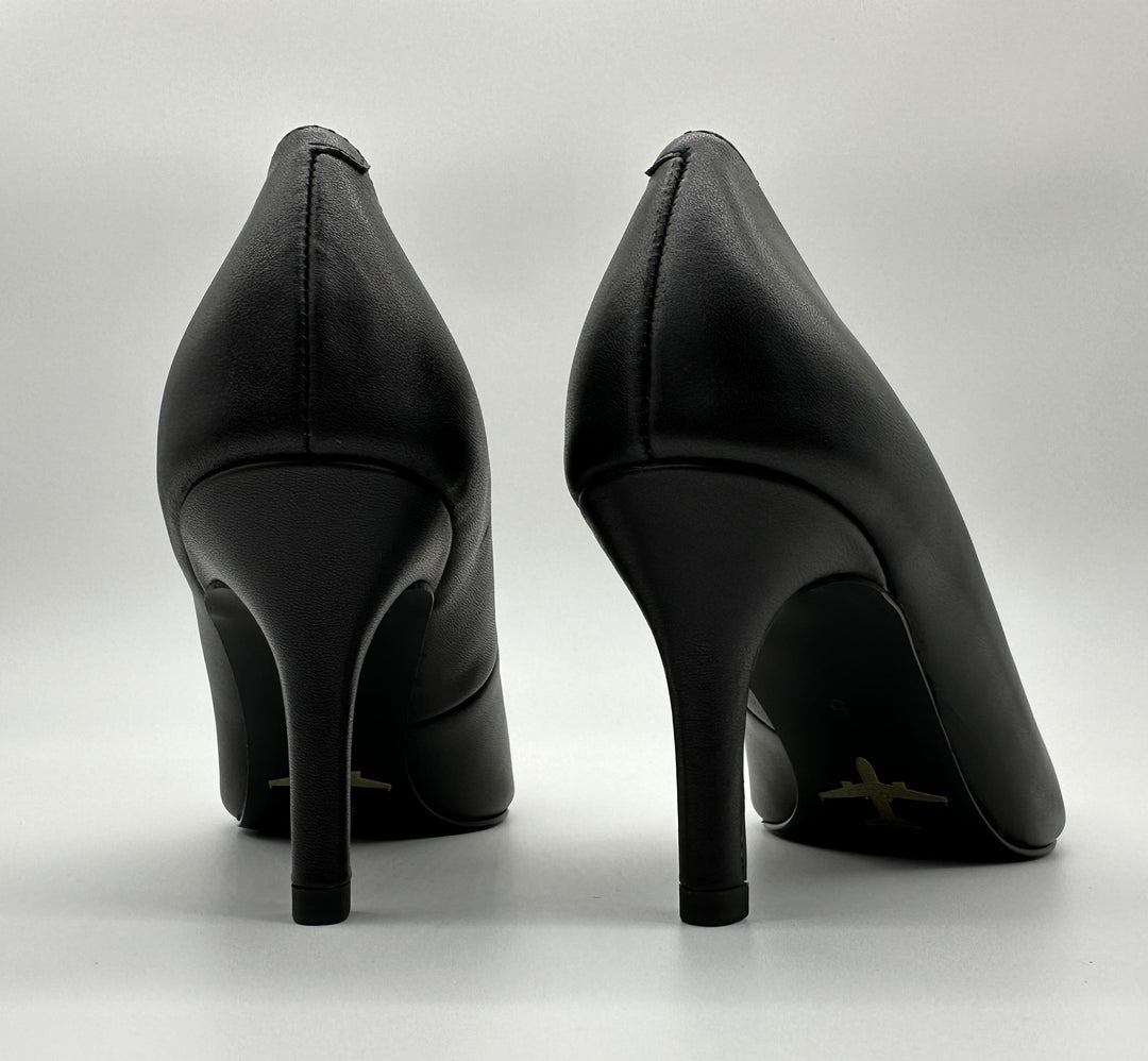 Classic black pump with a golden airplane image stamped against black outsole.