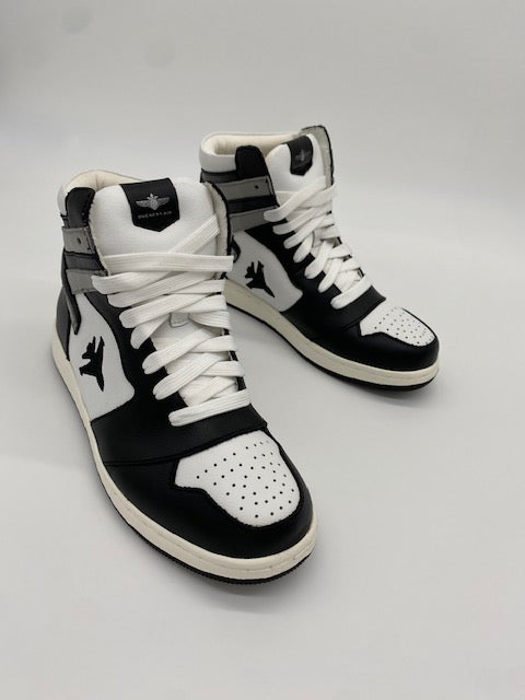 Black and white high top sneakers with Jet embroidered on the side with contrail.