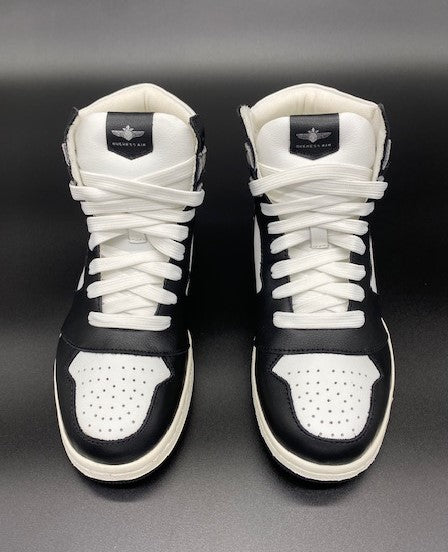 Black and white high top sneakers with Jet embroidered on the side with contrail.